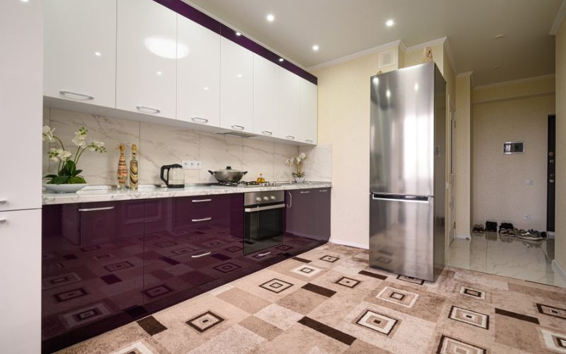 Purple cabinets and silver appliances in a modular kitchen