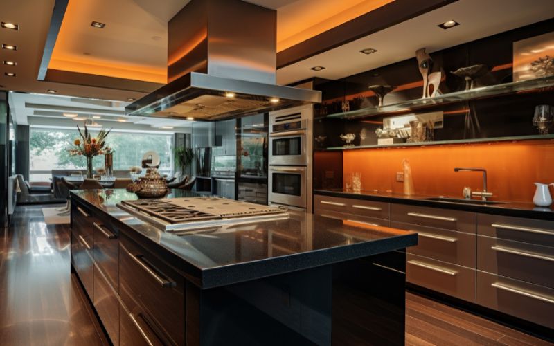 Modular kitchen with sleek black counter top and island, showcasing modern interior design.